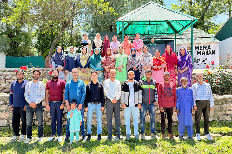 Teachers, parents and community members gathered for a group photograph at Army Good Will School Wuzur