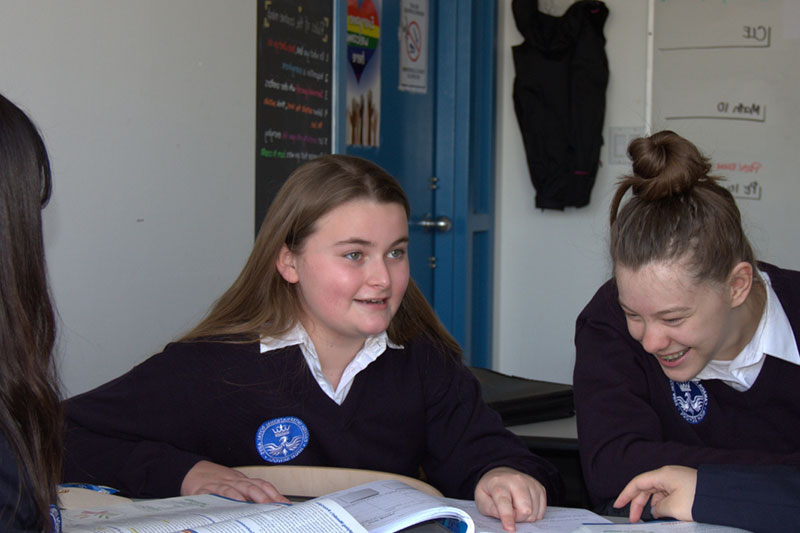 Students collaborating during a classroom discussion at Canada Royal Arts High School