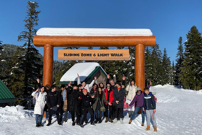Canada Royal Arts High School students enjoying a winter outdoor educational excursion in a snowy mountain setting