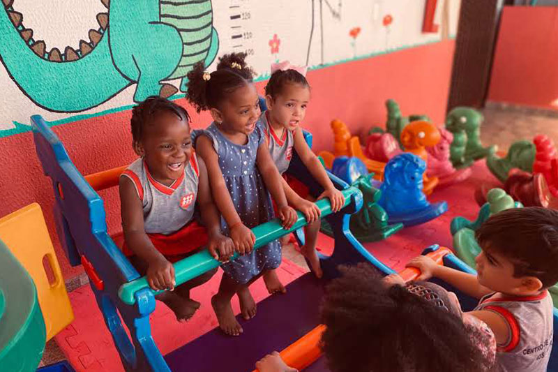 Children enjoying play-based learning activities in an early childhood development classroom at Fe y Alegría Brasil