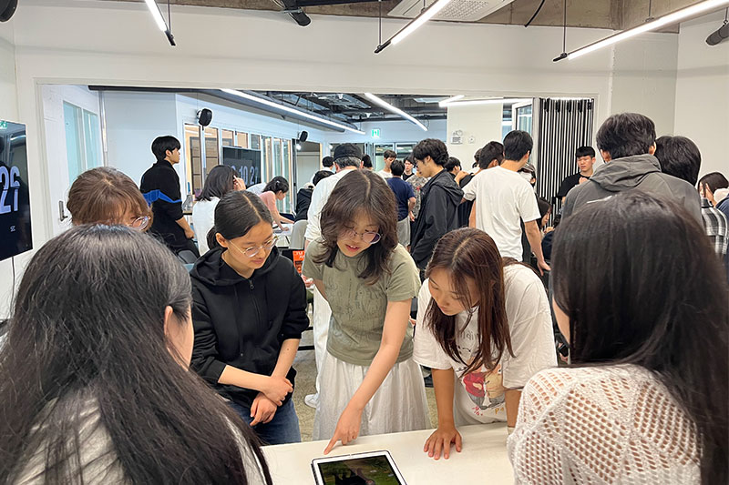 Students working together on a group project during a hands-on technology programme at G-School