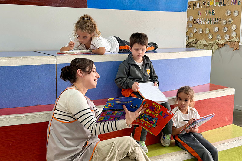 Teacher reading with young children in an early years classroom at Northfield School