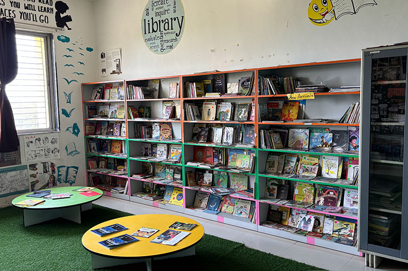 Well-stocked school library with children's books and reading spaces supporting literacy development