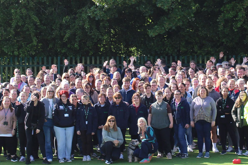 Staff members and educators gathered for a group photo at Five Acre Wood School celebrating teamwork and community
