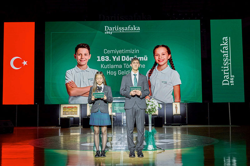 Darüşşafaka students presenting on stage during the foundation’s anniversary celebration event in Türkiye