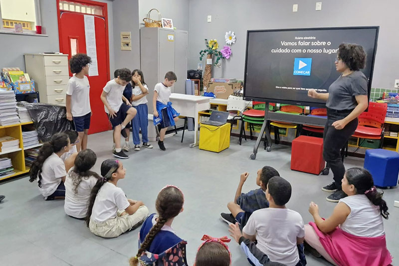 Students taking part in an interactive classroom lesson focused on community awareness and civic responsibility