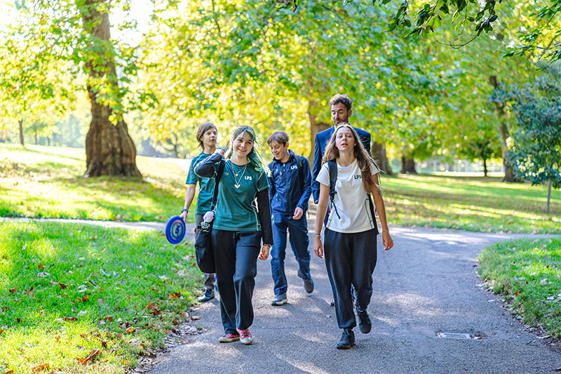 London Park School Hybrid students enjoying outdoor activities and social interaction in a green park setting