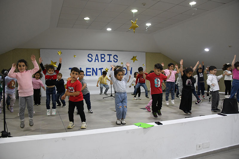 Young children participating in a music and movement performance at Leila C. Saad SABIS School El-Metn