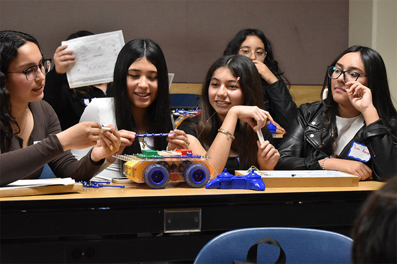Southwest Junior High School students collaborating on a robotics and engineering project during a STEM learning activity