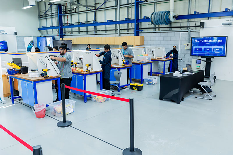 Students developing practical electrical installation and technical skills in a vocational training laboratory