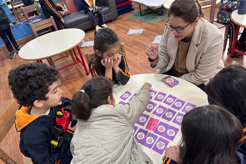 Teacher guiding young students through an interactive educational game at Beaconhouse TNS School