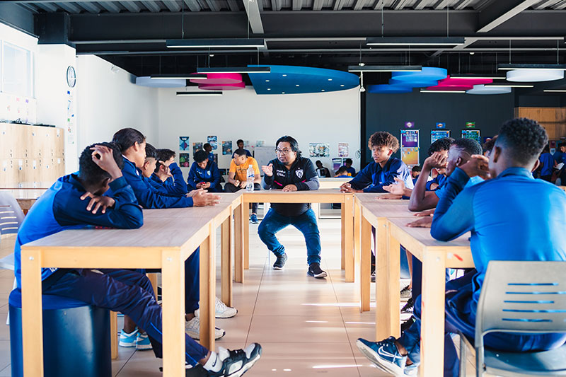 Students participating in a collaborative mentoring and leadership session in a modern learning environment
