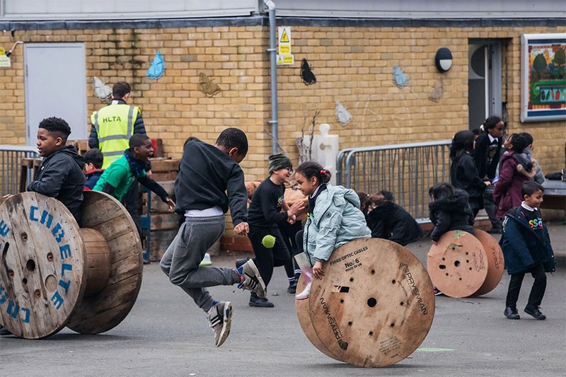 Students engaging in active outdoor play and teamwork activities in the SSQ School playground
